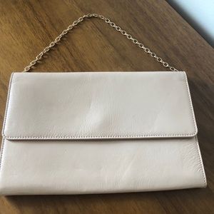 Cream clutch/purse with golden chain.